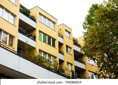 yellow apartment complex with tree