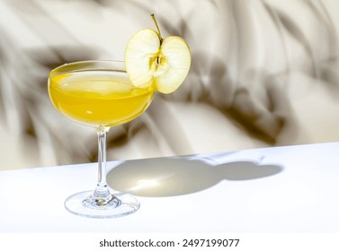 Yellow apple cocktail drink with vodka, gin, liqueur and syrup. on beige background, hard light - Powered by Shutterstock