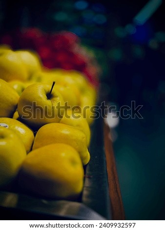 yellow apple fruits arranged neatly grocery store. Apple, Orange, Pomegranate.
