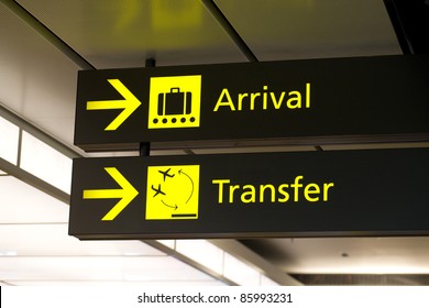 Yellow Arrivals & Transfer Sign At A International Airport