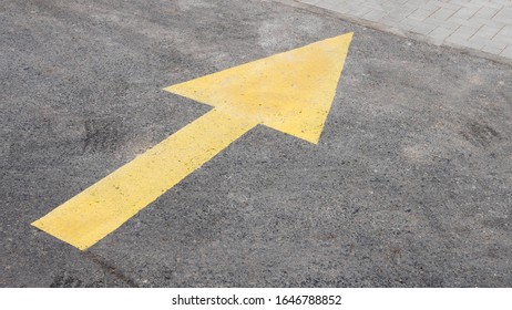 Yellow arrow on asphalt. Indicates the direction - straight ahead. - Shutterstock ID 1646788852