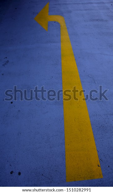 yellow arrow\
pointing left on floor car park\
