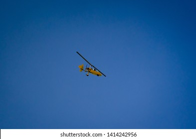 yellow autogyro flying above dead sea in jordan