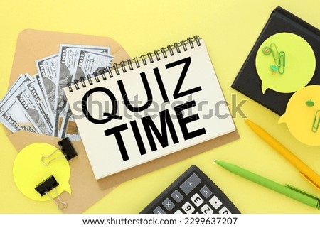 yellow background envelope with money. notepad with text. Its Quiz Time