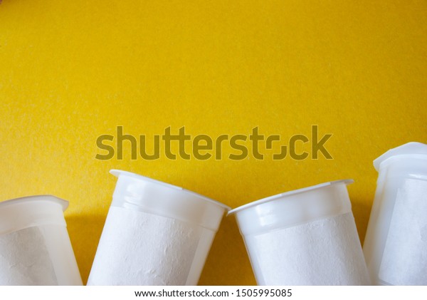 Download Yellow Background Several Yogurt Cups Bottom Stock Photo Edit Now 1505995085 PSD Mockup Templates
