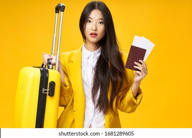 Yellow Background Suitcase And Airplane Ticket Passport