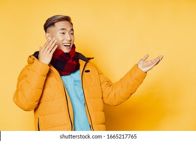 Yellow background young man warm jacket blue tank top - Powered by Shutterstock