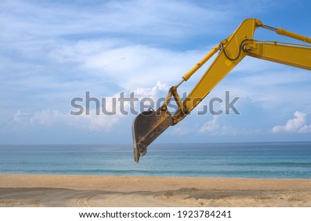 Yellow backhoe with hydraulic piston arm against blue sky. Heavy machine for excavation in construction site. Hydraulic machinery. Huge bulldozer. Heavy machine industry. Mechanical engineering.