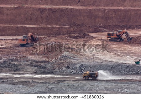 yellow backhoe work in coalmine.