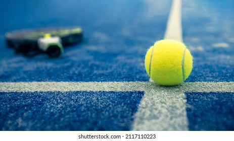 Yellow Ball On Floor Behind Paddle Net In Blue Court Outdoors. Padel Tennis Is A Racquet Game. Professional Sport Concept