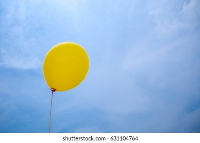 yellow balloon, feel good and glad in Blue Sky background. sign of emotion. image for background, wallpaper. copy space - Powered by Shutterstock