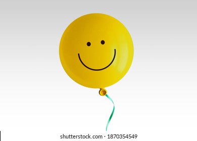 Yellow Balloon With Smile On White Background - Concept Of Optimism And Positive Thinking