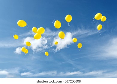Yellow balloons in blue sky.