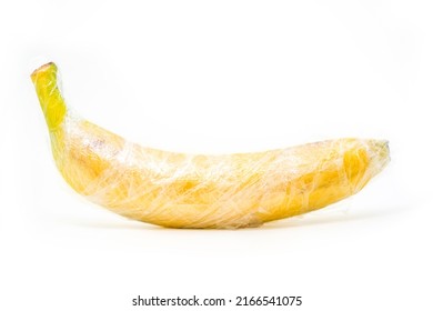 yellow banana is wrapped by plastic film,  protection concept
