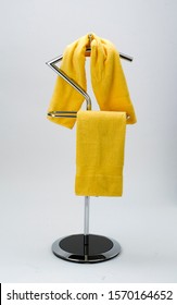 Yellow Bath Towels Hanging On Valet Stand. Isolated On White Background