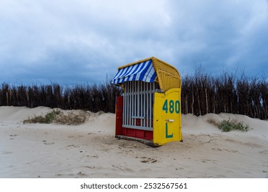 Yellow beach chair on the North Sea with a view to the mudflats at low tide - Powered by Shutterstock