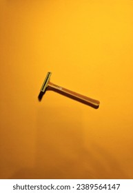 yellow beard shaver with an orange background