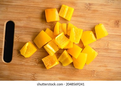 Yellow Bell Pepper Sliced into Large Chunks: Sweet yellow pepper cut into large pieces on a bamboo cutting board - Powered by Shutterstock