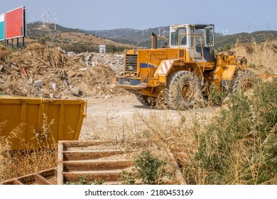 A Yellow Big Tractor Stands On A Construction Site. Construction Debris Removal. Clearing The Site For Construction.