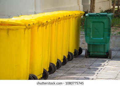 Yellow  bin for ordinary trash and green  bin for wet trash. It was set up in a community area. Trash is high to prevent garbage collection by animal.