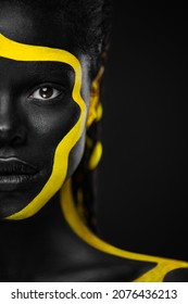 Yellow And Black Body Paint. Woman With Face Art. Young Girl With Colorful Bodypaint. An Amazing Afro American Model With Makeup.