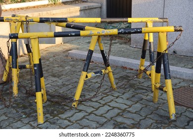 Yellow and Black Steel Barricades on the Road 