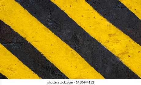 Yellow And Black Strip Paint On Road Surface; Asphalt Road Texture Sign