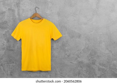 Yellow Blank Cotton Tshirt Hanging Center Gray Concrete Empty Wall Background.