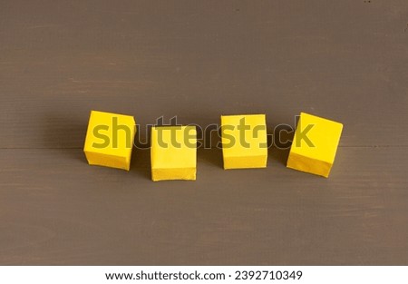 Yellow blank paper cubes on a dark background