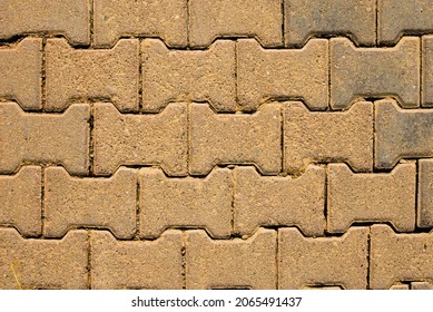 Yellow block pavior driveway. Seamless texture of street tiles. Pattern of yellow sidewalk tiles. Paved path pattern, brick path road. Cobblestone textured detailed ground concrete pavement.