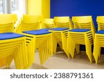 Yellow and blue chairs stacked together create beautiful lines.