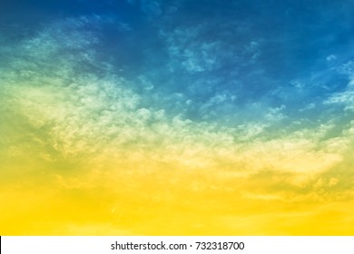 Yellow And Blue Color With Green Light In Sky  And Soft Clouds