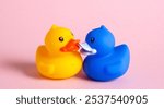 Yellow and blue ducks kiss on pink background.