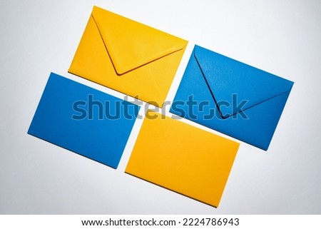 Yellow and blue envelopes on a white background. A set of envelopes in different types. Paper envelopes for inscriptions. Top view mockup