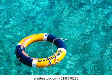 A Yellow And Blue Lifesaver Ring In Ocean In Grand Baie