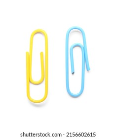 Yellow and blue paper clips on white background - Shutterstock ID 2156602615