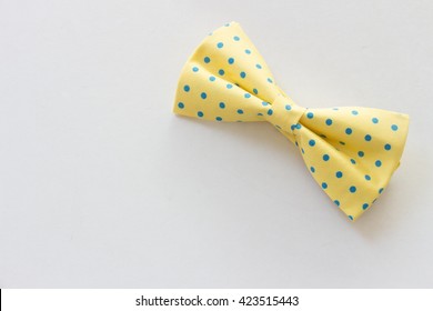 Yellow and blue polka dot bow tie isolated on white background - Powered by Shutterstock