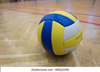 Yellow Blue White Volleyball On The Ground In The School Gym
