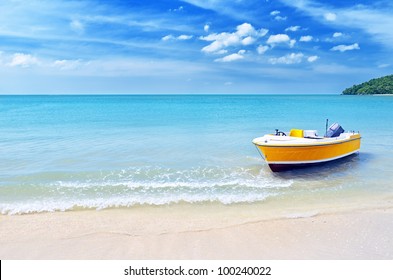 Yellow Boat On A Beach.
