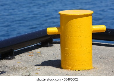 Yellow bollard at a marina. - Powered by Shutterstock