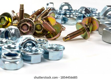 yellow bolts with washers and shiny nuts on a white background - Shutterstock ID 1854456685