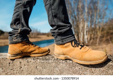 Yellow Boots With Thick Soles For Hard Work And Walking, Man In Shoes Outdoors