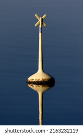 Yellow Bouy In Calm Water With Reflection