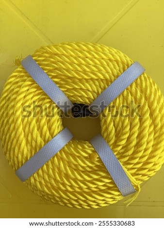 Yellow braided rope on a yellow table.