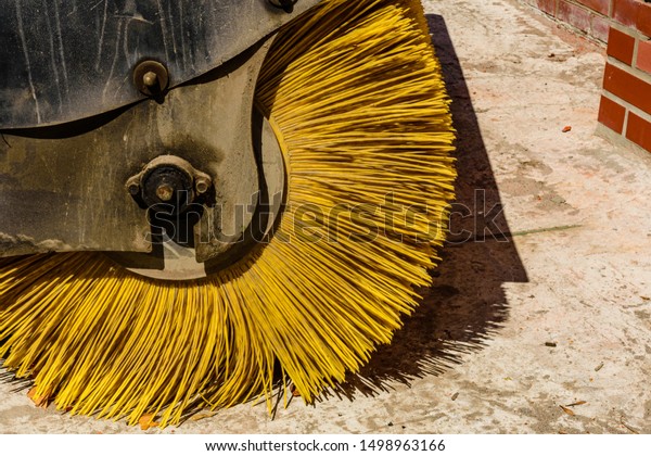 Yellow brush of the\
road cleaning machine
