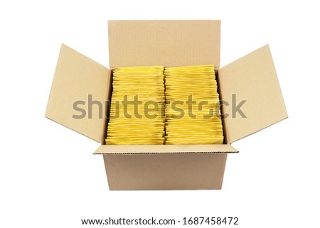 Lot of yellow bubble envelopes inside an opened cardboard box isolated on white.