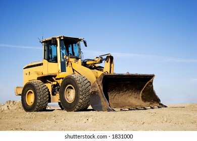 Yellow Bulldozer Dumping Dirt