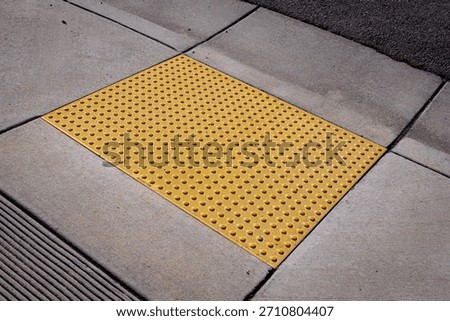 Yellow bumpy tiles, detectable warning surfaces or truncated domes, a tactile paving designed to assist blind or visually impaired people, required by Americans with Disabilities Act (ADA) in USA 
