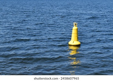 A yellow buoy floating in the waters off of the Scottish coast - Powered by Shutterstock