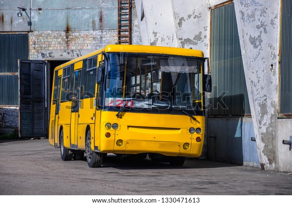 Yellow bus at the\
depot.